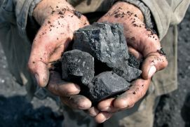 Close-up of coal in the hands of a miner