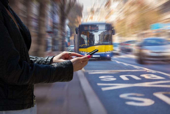 Woman using cellphone and crossing the street