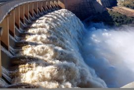 Scenic view of a dam surrounded by green mountains 