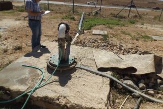 Dr. Hamdan collecting data on groundwater wells. They serve as a basis for studies on the proper management of well fields.