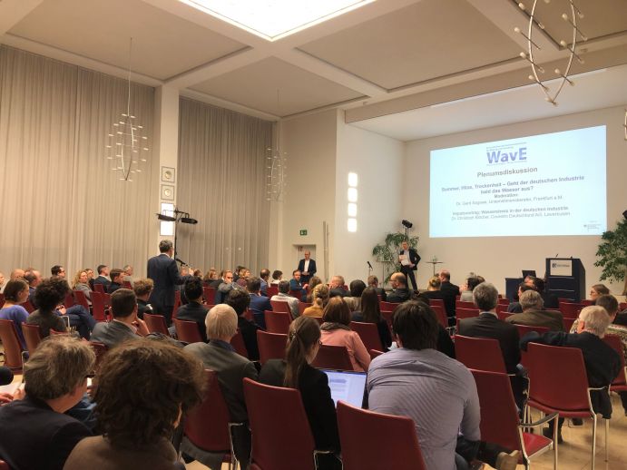 Die WavE-Statuskonferenz bot Teilnehmenden aus Wirtschaft, Politik, Verwaltung, Wissenschaft sowie Bundes- und Landesbehörden die Möglichkeit, mehr über die aktuellen Erkenntnisse im Bereich "Wasserwiederverwendung" zu erfahren Saal mit Konferenzteilnehmenden bei einer Podiumsdiskussion